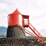 Cross Cultural Cuisine - a red tower sitting on top of a stone wall