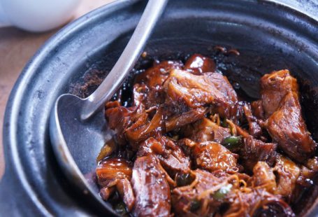 Ayurvedic Cuisine - meat with sauce in black bowl