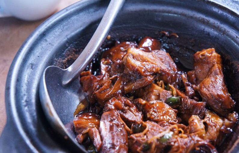 Ayurvedic Cuisine - meat with sauce in black bowl