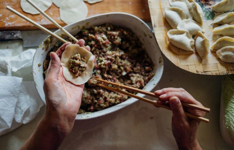 Chinese Cuisine - person making dumplings