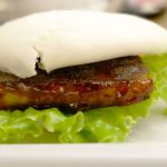 Fusion Cuisine - a close up of a plate of food with meat and lettuce