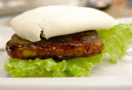 Fusion Cuisine - a close up of a plate of food with meat and lettuce