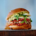 Gourmet Vegan - selective focus photography of hamburger with sliced tomatoes and vegetables