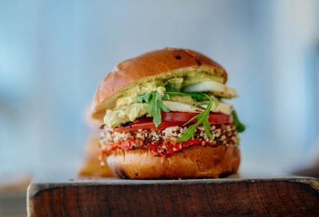 Gourmet Vegan - selective focus photography of hamburger with sliced tomatoes and vegetables