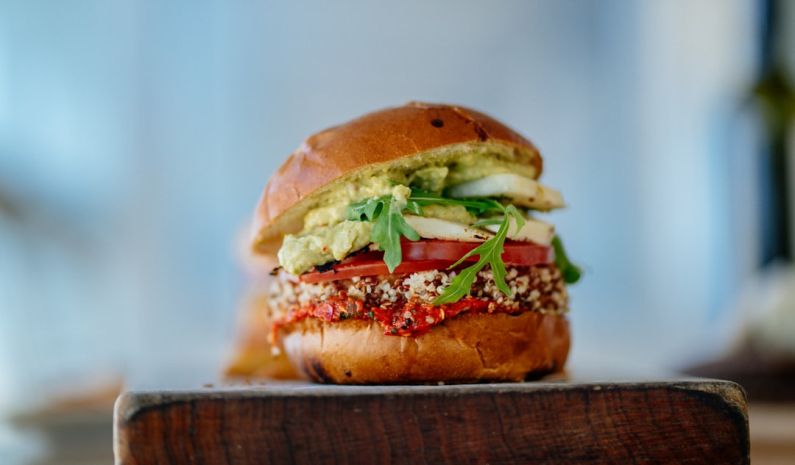 Gourmet Vegan - selective focus photography of hamburger with sliced tomatoes and vegetables