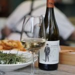 Greek Cuisine - wine bottle beside wine glass on table