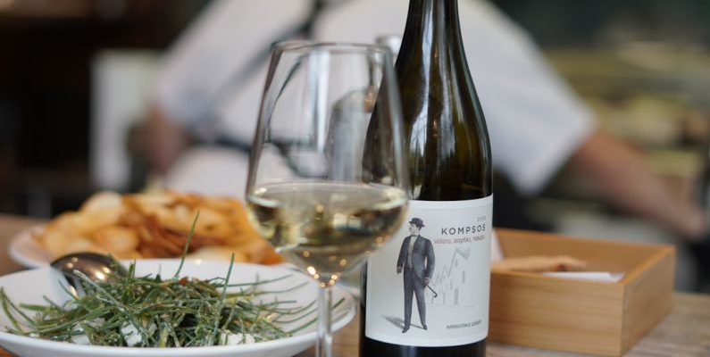 Greek Cuisine - wine bottle beside wine glass on table