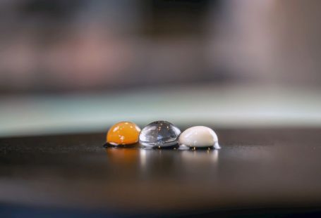 Molecular Gastronomy - three marbles sitting on top of a wooden table