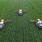 Smart Agriculture - yellow and black heavy equipment on green field during daytime