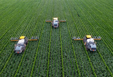Smart Agriculture - yellow and black heavy equipment on green field during daytime