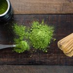 Matcha Tea - green powder and spoon on board