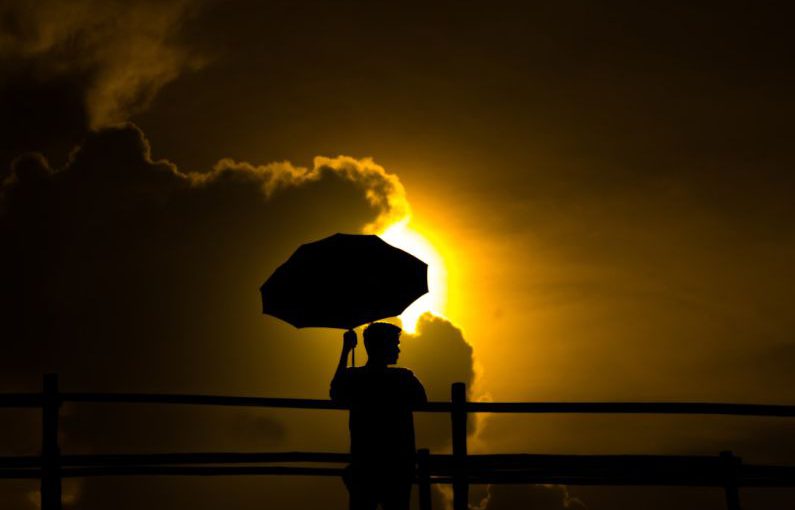 Health Food Trends - a person holding an umbrella in front of the sun