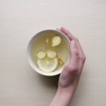 Low FODMAP Food - person holding white bowl with sliced lime and ginger inside