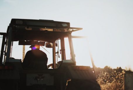 Digital Farming - silhouette of man riding tractor