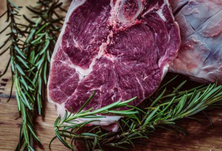 In-vitro Meat - raw meat and green leaf plant on brown surface