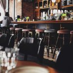 AR VR Restaurant - two person sitting on bar stool chair in front of bar front desk
