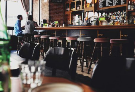 AR VR Restaurant - two person sitting on bar stool chair in front of bar front desk